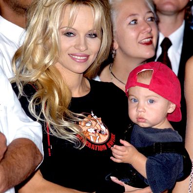 Pamela Anderson and son Brandon during Motley Crue Puts Hands in Cement in RockWalk at Guitar Center in Hollywood, California, United States. 